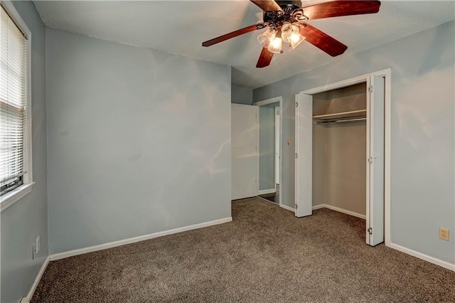 unfurnished bedroom with carpet, a closet, ceiling fan, and baseboards