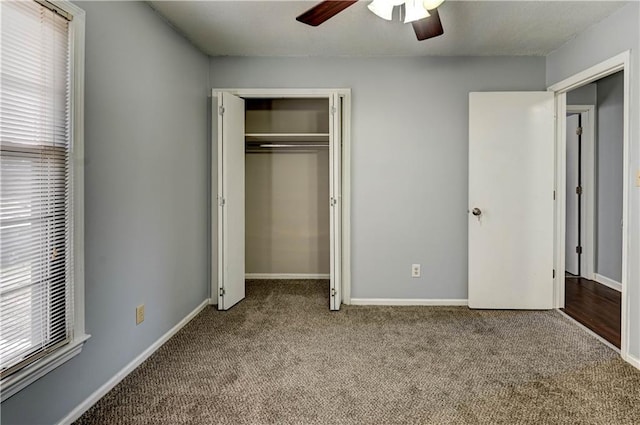 unfurnished bedroom with multiple windows, baseboards, a closet, and light colored carpet