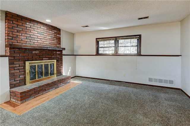 unfurnished living room featuring carpet floors, baseboards, a fireplace, and visible vents