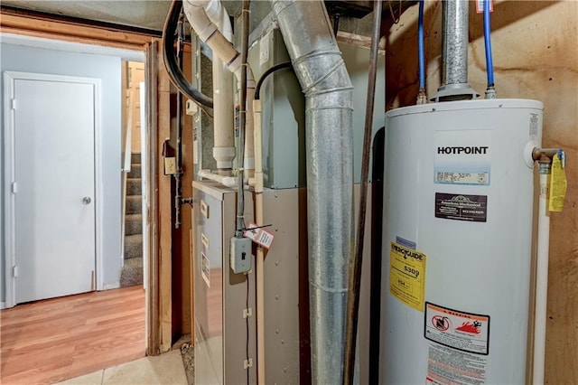 utility room featuring water heater