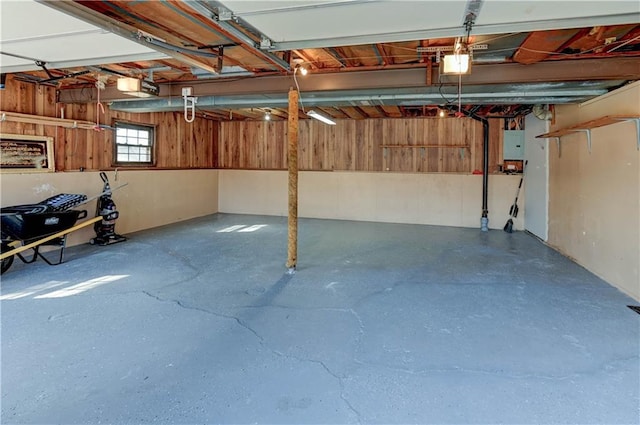 garage with a garage door opener and electric panel