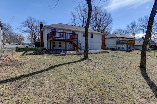 rear view of property with a chimney, stairs, fence, a deck, and a yard