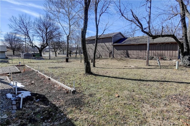 view of yard with fence and a vegetable garden