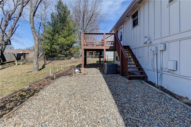 view of yard featuring central AC unit, stairway, fence, and a wooden deck