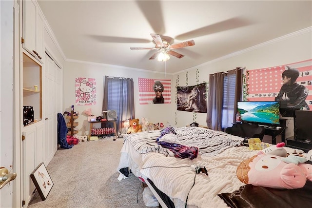 carpeted bedroom with a ceiling fan, a closet, and crown molding