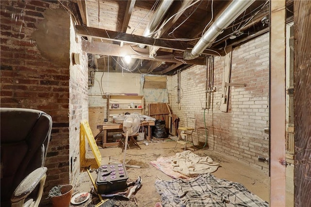 unfinished basement featuring brick wall