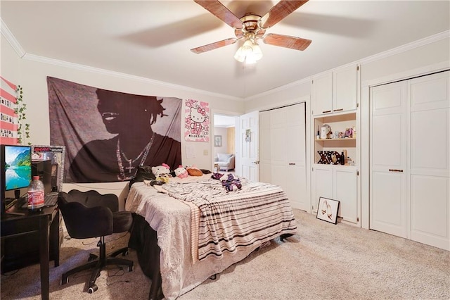 bedroom featuring a ceiling fan, ornamental molding, two closets, and light colored carpet