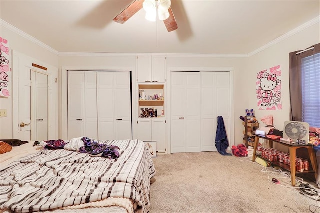 bedroom featuring light carpet, crown molding, ceiling fan, and multiple closets