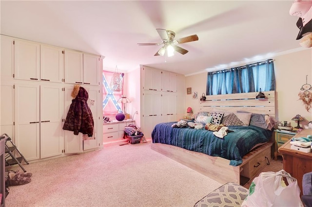 bedroom featuring light carpet, ceiling fan, and crown molding