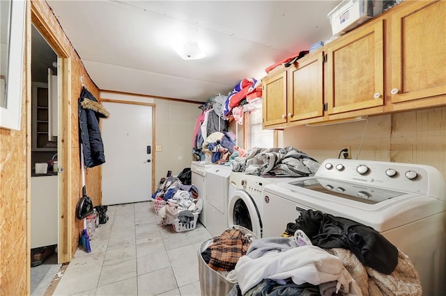 clothes washing area with cabinet space and washer and clothes dryer