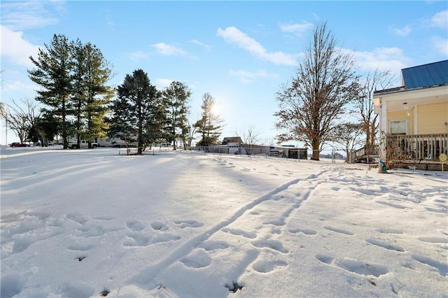 yard covered in snow featuring fence