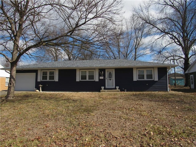 ranch-style house featuring a front lawn, a shingled roof, and an attached garage