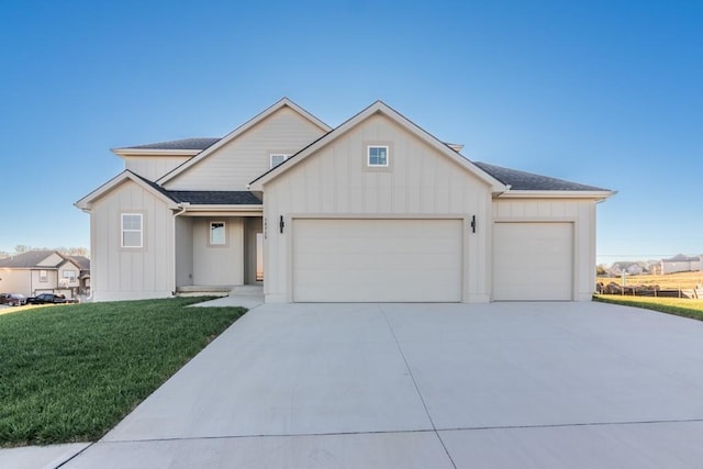 modern farmhouse style home featuring roof with shingles, concrete driveway, an attached garage, board and batten siding, and a front yard