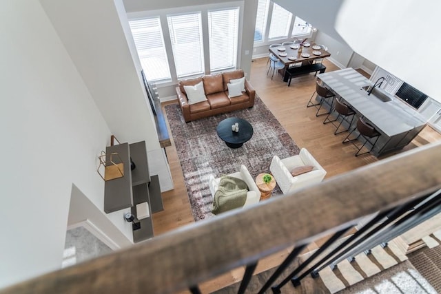 living area featuring baseboards and light wood-style floors