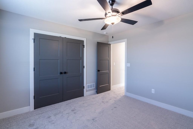 unfurnished bedroom with carpet, a closet, visible vents, and baseboards