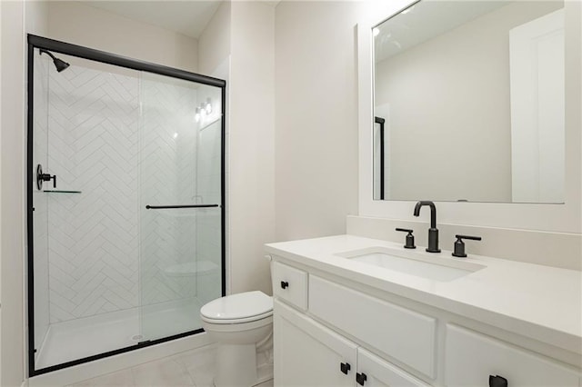 full bath featuring a stall shower, vanity, and toilet