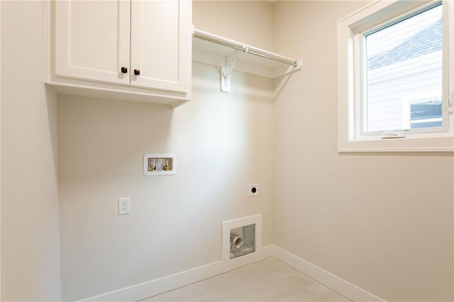 washroom with baseboards, hookup for a washing machine, cabinet space, and hookup for an electric dryer