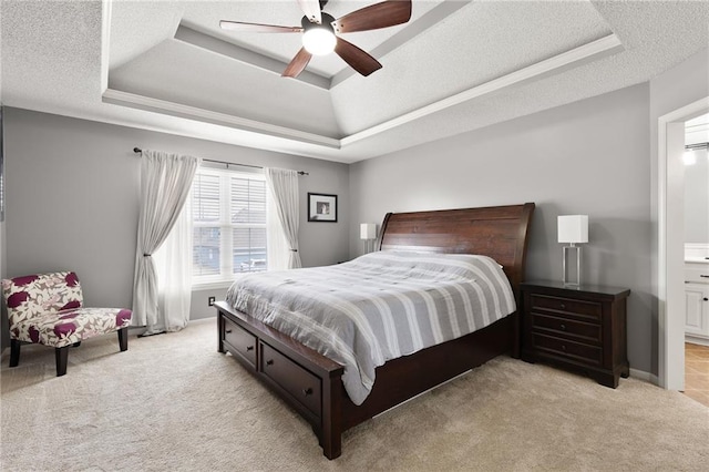 bedroom featuring a tray ceiling, a textured ceiling, and light colored carpet