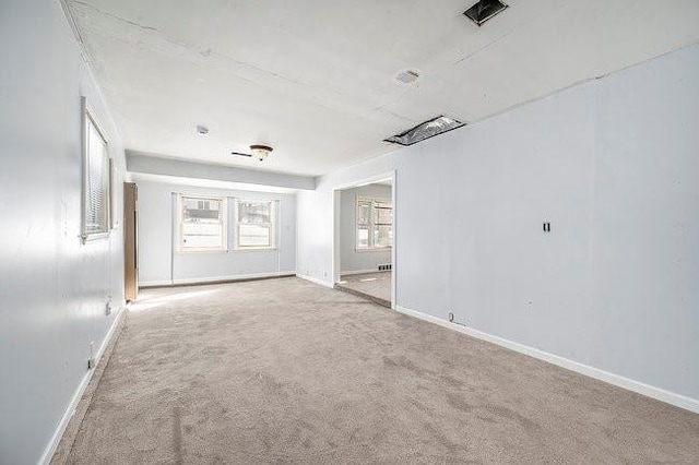 unfurnished room featuring light carpet, baseboards, and visible vents