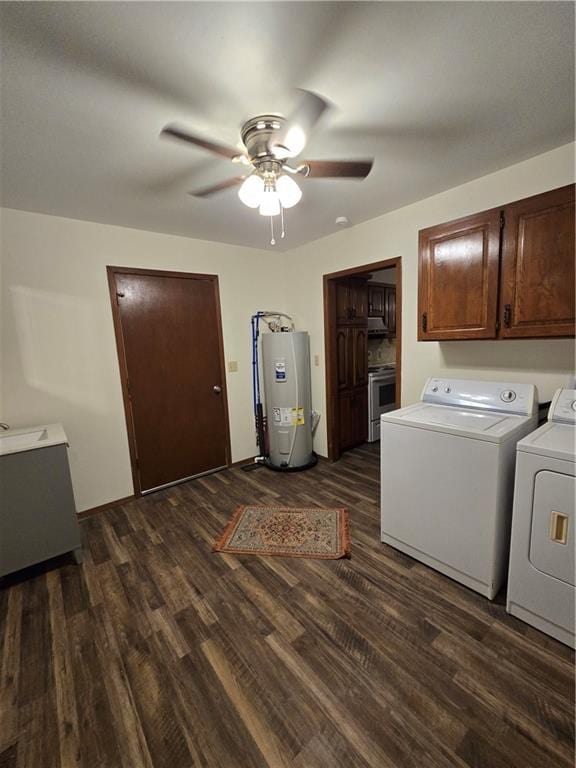 laundry room featuring dark wood-type flooring, electric water heater, cabinet space, and separate washer and dryer