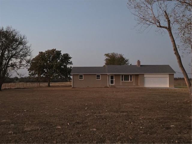 single story home featuring a garage and a chimney