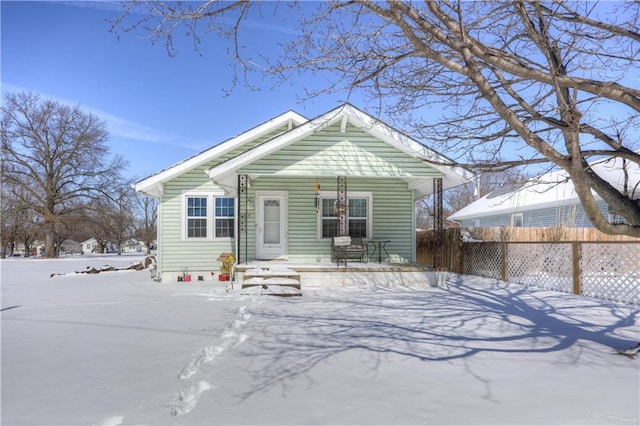 view of front facade featuring a porch and fence