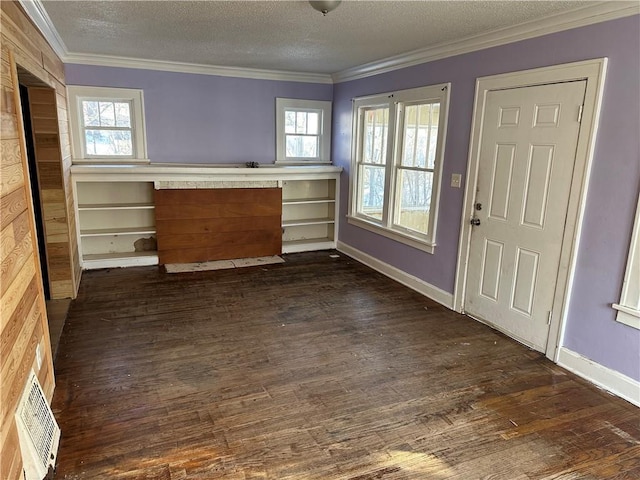 interior space featuring a textured ceiling, visible vents, dark wood-type flooring, and crown molding