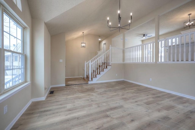 interior space with a healthy amount of sunlight, stairway, light wood-type flooring, and baseboards