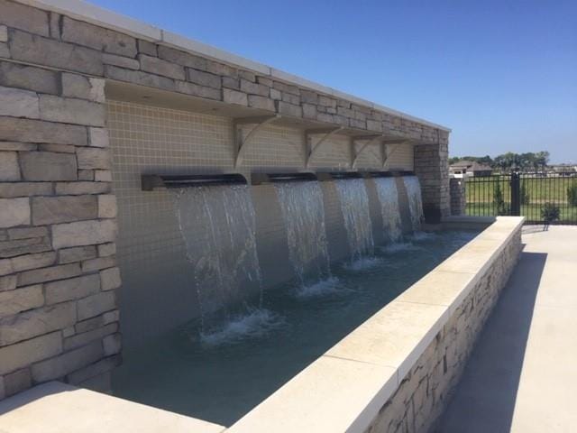 view of swimming pool with fence