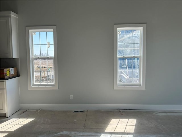 unfurnished dining area with visible vents