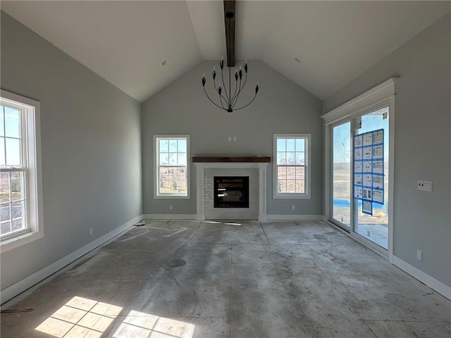 unfurnished living room featuring lofted ceiling, a notable chandelier, a fireplace, and baseboards