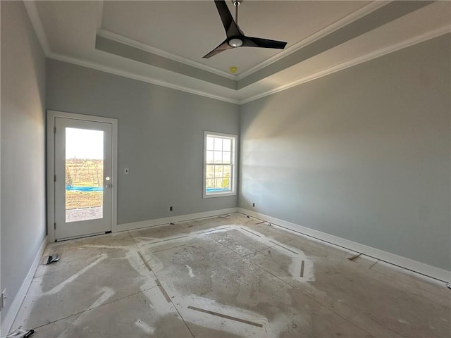 empty room featuring crown molding, baseboards, a raised ceiling, and a ceiling fan