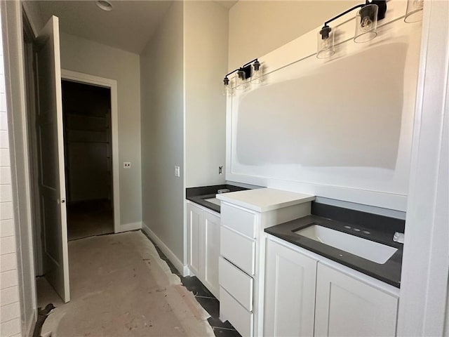 bathroom with baseboards and concrete flooring