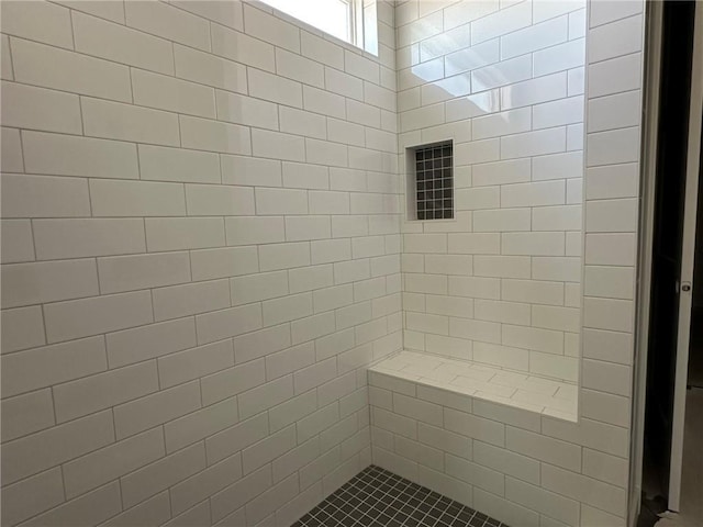 bathroom with a tile shower