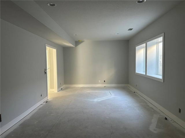 unfurnished room with baseboards