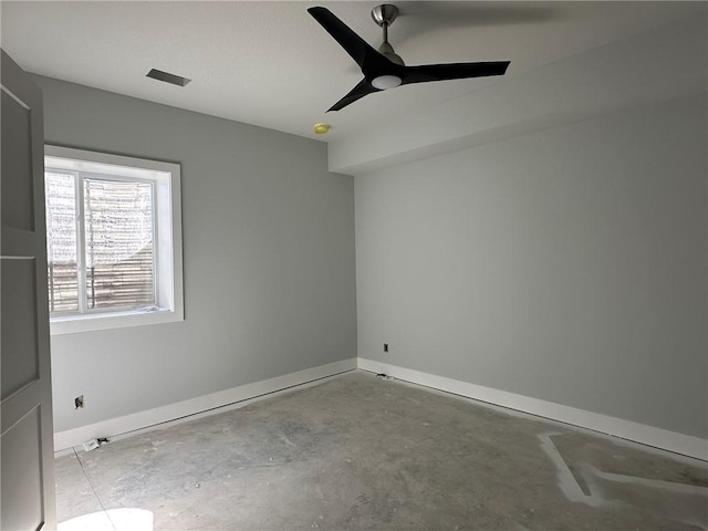 empty room with visible vents, a ceiling fan, unfinished concrete flooring, and baseboards