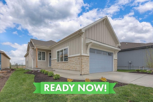 17372 S Kaw St, Olathe, KS 66062 - view of front of property with board and batten siding, stone siding, driveway, a front yard, and an attached garage