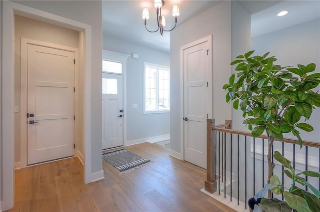 17372 S Kaw St, Olathe, KS 66062 - entryway with wood finished floors, baseboards, a chandelier, and recessed lighting