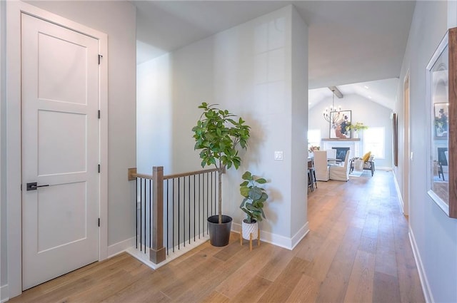 17372 S Kaw St, Olathe, KS 66062 - hallway featuring light wood-type flooring, lofted ceiling, and baseboards