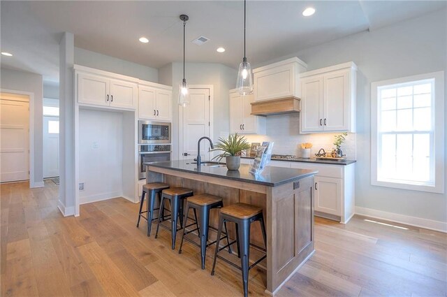 17372 S Kaw St, Olathe, KS 66062 - kitchen featuring appliances with stainless steel finishes, dark countertops, a sink, white cabinetry, and recessed lighting