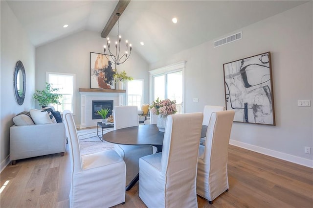 17372 S Kaw St, Olathe, KS 66062 - dining space with wood finished floors, a glass covered fireplace, baseboards, recessed lighting, and a chandelier