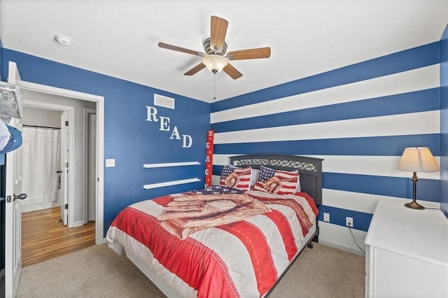 bedroom featuring a ceiling fan, light carpet, visible vents, and baseboards