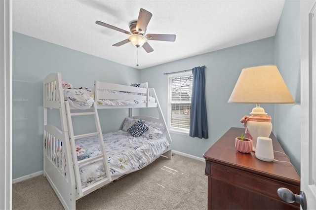 bedroom with light colored carpet, ceiling fan, and baseboards