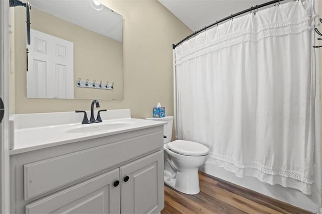 bathroom with shower / tub combo, vanity, toilet, and wood finished floors