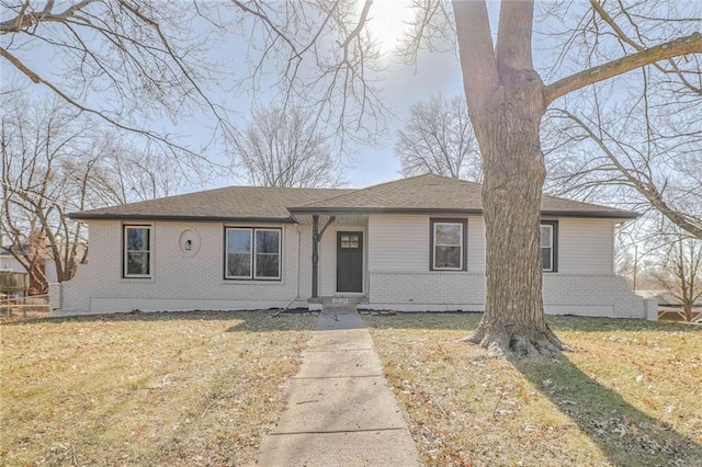 single story home featuring brick siding and a front yard