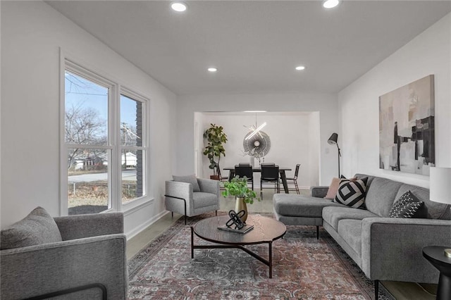 living area featuring recessed lighting, dark wood finished floors, and baseboards