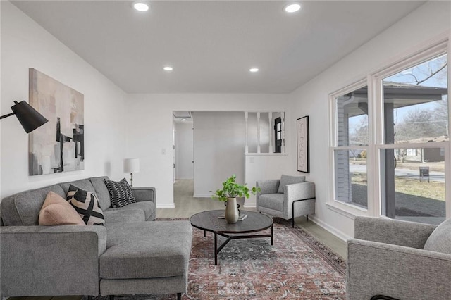 living room with recessed lighting, baseboards, and wood finished floors