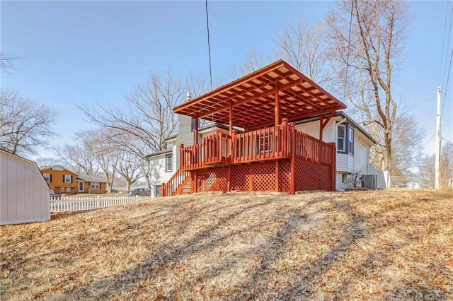 back of property featuring a deck, central air condition unit, stairs, and fence