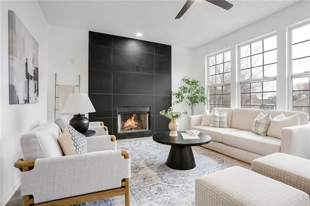 living area with a large fireplace, ceiling fan, wood finished floors, and recessed lighting