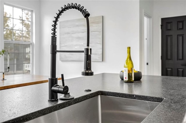 interior details with dark countertops and a sink